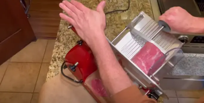 Slicing meat with slicer