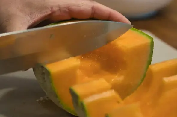 Slicing Cantaloupe With A Knife Slicing Cantaloupe In Cubes With A Knife