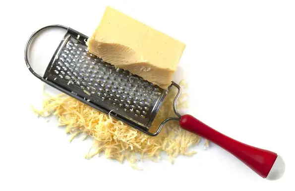 Handheld cheese grater