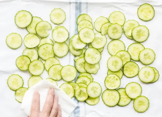 Place the sliced cucumbers in a single layer on a paper towel Place the sliced cucumbers in a single layer on a paper towel