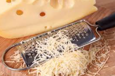 Shredding sliced cheese with zester