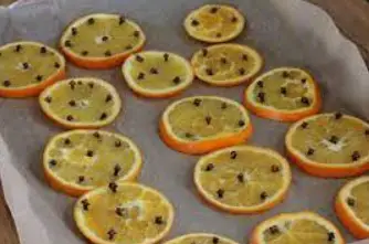 Take a few cloves and insert one in each orange slice Take a few cloves
