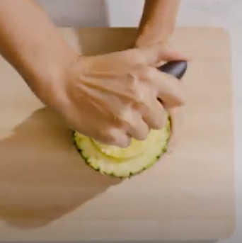 Twist the slicer into the pineapple