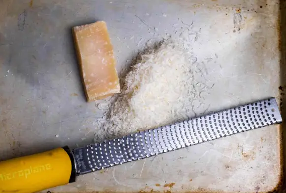 Grating cheese using a zester