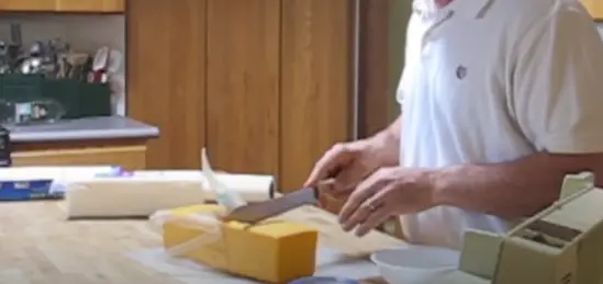 Place the cheese on the cutting board Place the cheese on the cutting board