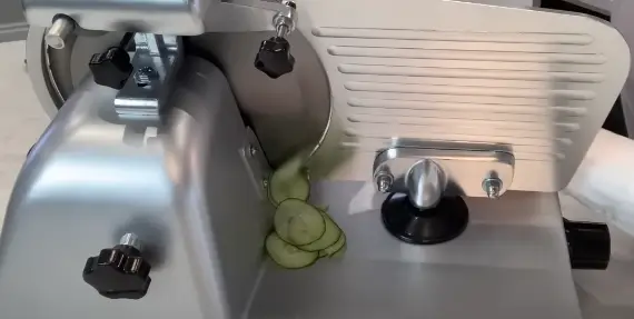Press the vegetable firmly against the cutting surface Press the vegetable firmly against the cutting surface