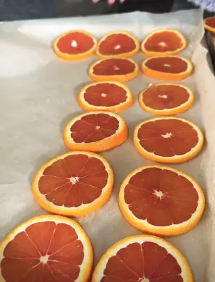 After slicing, arrange the orange slices on a baking sheet lined with parchment paper. After slicing, arrange the orange