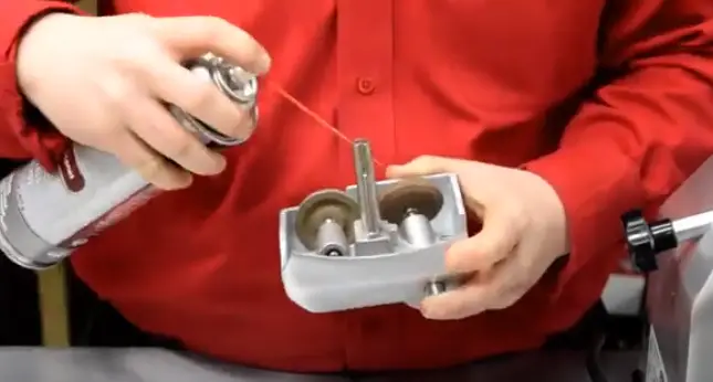 Apply the aerosol spray or gel lubricant behind the stones Lubricate the Sharpening Stones