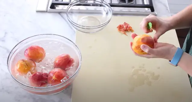 Once the peaches have cooled, begin peeling the skin starting from the 'X' mark Once the peaches have cooled
