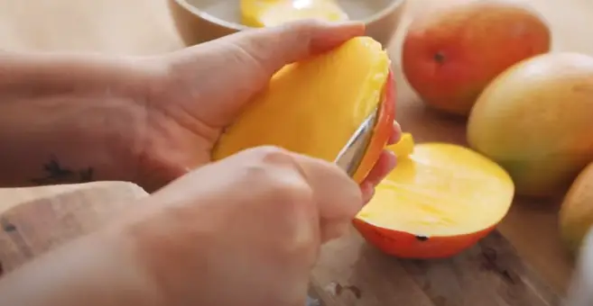 Peel the mangoes and ensure they are ready for slicing Peel the mangoes