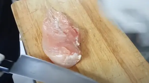 Place the chicken breast flat on a cutting board