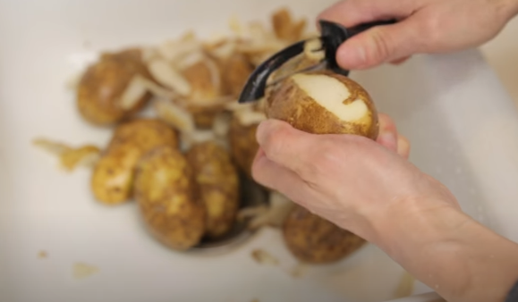 Place the potato peeler against the top of the skin