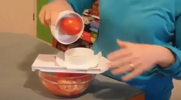Place the tomato on the Pampered Chef slicer