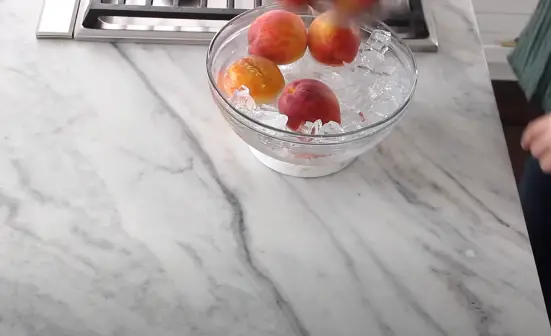 Remove the peaches from the pot and let them cool on a plate Remove the peaches