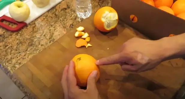 slide the blade of your knife between the orange flesh and the inner white membrane Start from one end