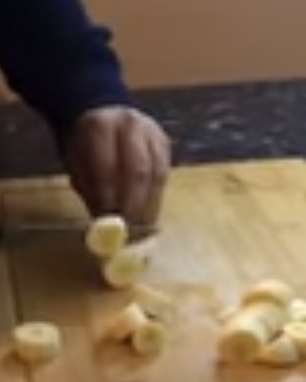 Using a sharp knife, carefully slice down the length of the banana